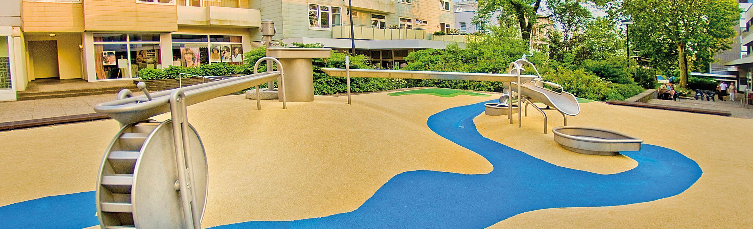 REGUPOL playfix aqua - Safe and barrier-free water playground with innovative safety flooring Barrier-free water playground with non-slip, water-permeable REGUPOL playfix aqua safety flooring, complete with interactive water elements.