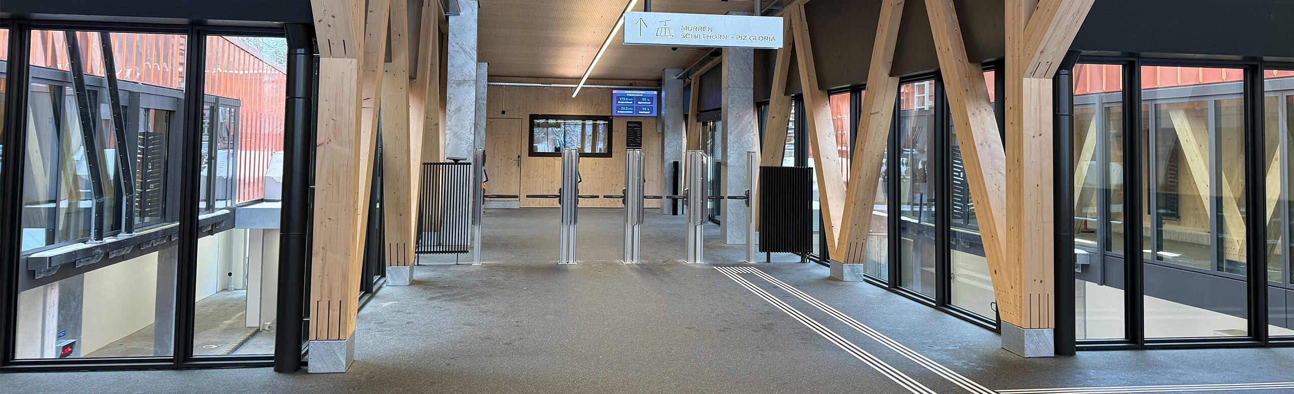Railway station with REGUPOL everroll alpine ultimate flooring in the trend colour grey. Wood and glass is used for the building as well to create a modern but still warm feeling. 